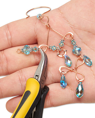 Pliers attaching beads to wire shapes